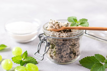 Mint sugar with mint leaves in glass jar. Green candies.