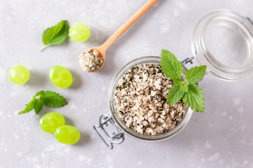 Peppermint sugar and spearmint candy. Sweet hard candy and leaves of fresh mint. Top view.