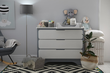 Beautiful baby room interior with modern changing table