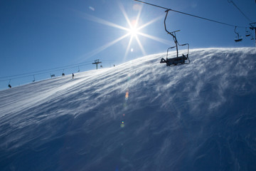 Fototapeta na wymiar Chair lift, on a bright winter day in the village of Sheregesh, top Green