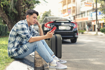 Asian man waiting for Uber taxi