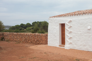 Fototapeta na wymiar Typical white house in the Balearic Islands with a drain.