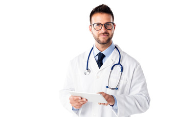 Portrait shot of male doctor using digital tablet while standing at isolated white background