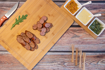 Grilled sausages with spices and sauces on the table