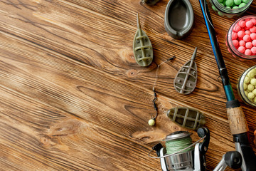 Accessories for carp fishing and fishing baits on wooden planks with copy space