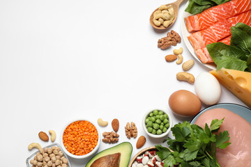 Different products rich in protein on white background, flat lay