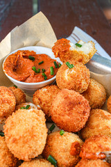 Cheese balls with tomato sauce. Fried snack starter meal. Party food