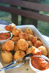 Cheese balls with tomato sauce. Fried snack starter meal. Party food