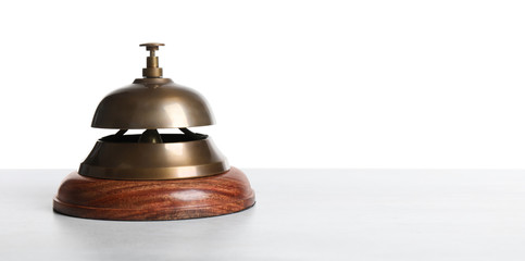 Hotel service bell on wooden table against white background