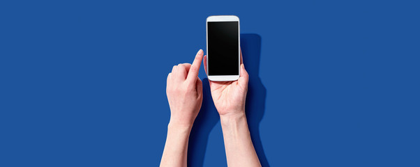 Obraz na płótnie Canvas Person using a white smartphone from above