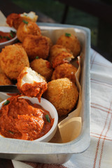 Cheese balls with tomato sauce. Fried snack starter meal. Party food