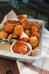 Cheese balls with tomato sauce. Fried snack starter meal. Party food