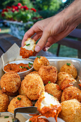 Cheese balls with tomato sauce. Fried snack starter meal. Party food
