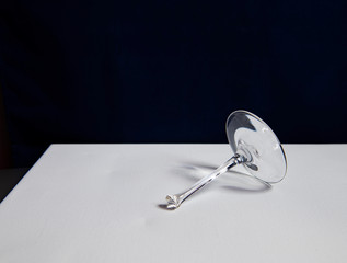 still life with broken glass goblet on dark background