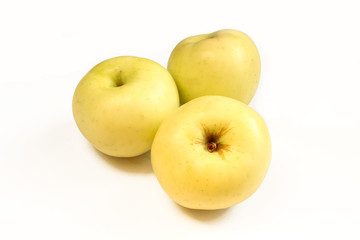 Three yellow apples isolated on white background. Above and closeup