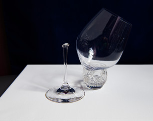 still life with broken glass goblet on dark background