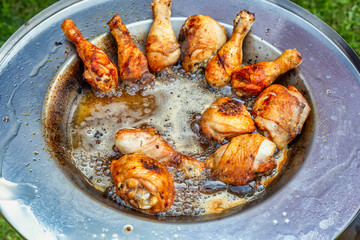 Chicken frying in hot oil dish plate