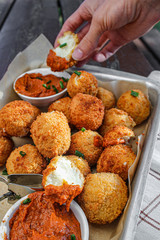 Cheese balls with tomato sauce. Fried snack starter meal. Party food