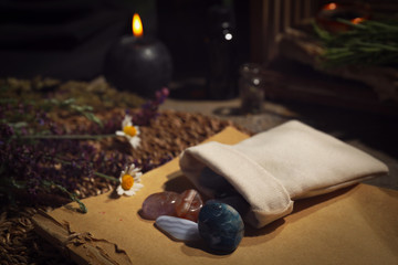 Naklejka na ściany i meble Bag with gemstones and healing herbs on table