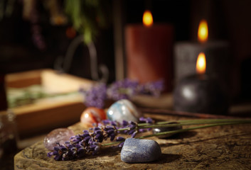 Gemstones and healing herbs on wooden board
