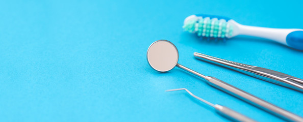 Professional dentist tools on blue background