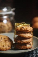 Homemade drop cookies or chocolate chip cookies over dark background 