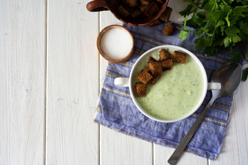 Vegetarian food: Cream soup with fresh vegetables in a white plate on a white background