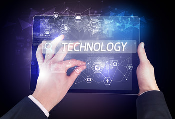 Close-up of a tablet searching TECHNOLOGY inscription, hi-tech computing concept