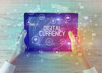 Close-up of a tablet with DIGITAL CURRENCY inscription, innovative technology concept