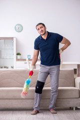 Young leg injured contractor cleaning the house