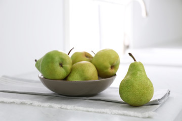 Fresh ripe pears on countertop in kitchen