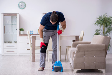 Young leg injured contractor cleaning the house