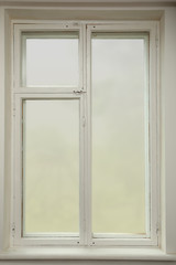 Old white window with wooden sill in room
