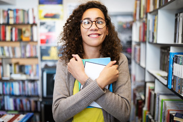 Ready to study hard. Happy nerd woman in library. Book lover.