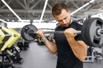 strong fit caucasian muscular man with big muscles doing barbell weight lifting cross training,...