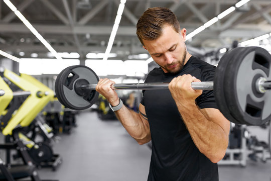 strong fit caucasian muscular man with big muscles doing barbell weight lifting cross training, bodybuilding concept