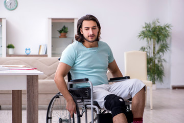 Young student in wheel-chair studying at home