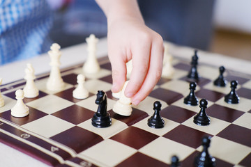 boy, kid plays with his father, an adult in chess, the concept of the development of mental...