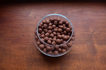 Breakfast. Chocolate balls from cocoa in a beautiful transparent glass on a dark background.