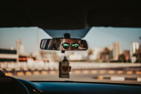 Man looking at back side mirror