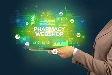 Close-up of a touchscreen with PHARMACY WEBSHOP inscription, medical concept