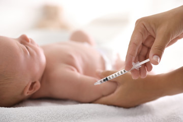 Obraz na płótnie Canvas Doctor vaccinating cute baby, closeup. Health care