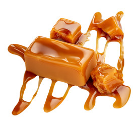 Composition of soft caramel candies isolated on white background, top view. Sweet caramel pieces with sauce or  maple syrup