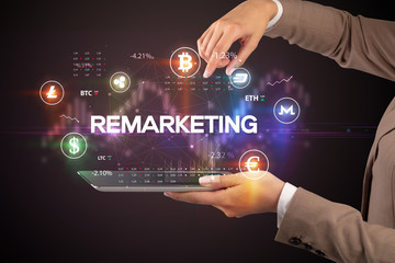 Close-up of a touchscreen with REMARKETING inscription, business opportunity concept