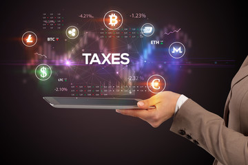 Close-up of a touchscreen with TAXES inscription, business opportunity concept