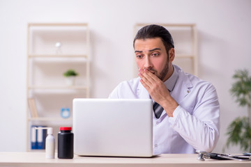 Young male doctor working in the clinic