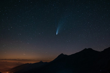 comet Neowise twin tails glowing in the night sky. Telephoto view, details of the two star trails....