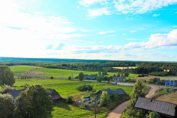 Fototapeta na wymiar View of the Russian village green fields of the taiga