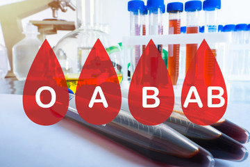 Blood donation. Logos of blood groups on background of laboratory assistant table. Center for...