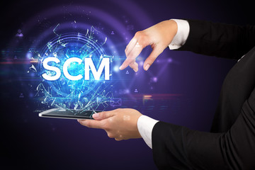 Close-up of a touchscreen with SCM abbreviation, modern technology concept